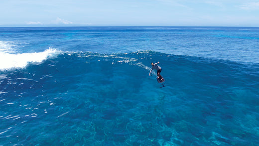 eFoil surfer carving along the top of a newly formed wave